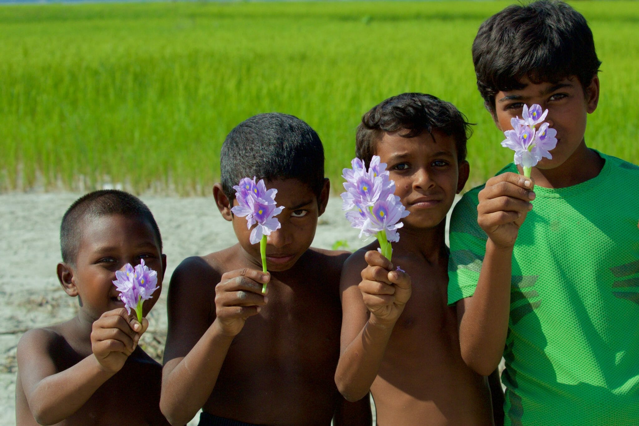 4 boys offering a flower Chars Bangladesh-11-2015