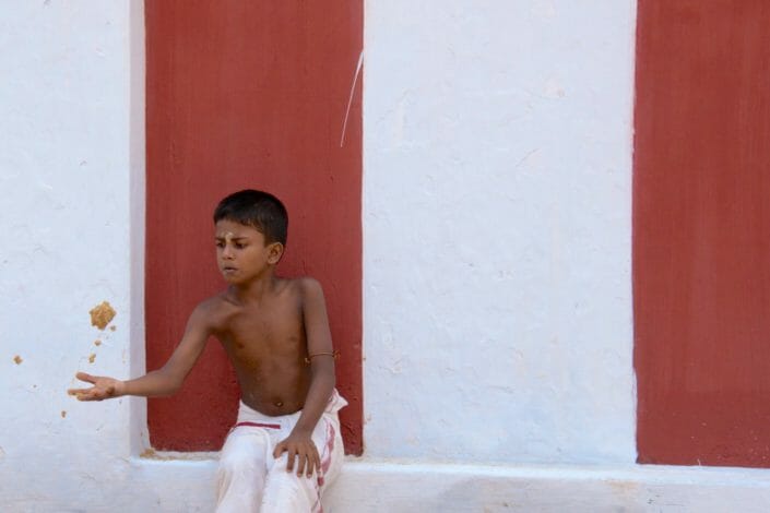Boy playing under the temple walls Jaffna Sri Lanka August 2013